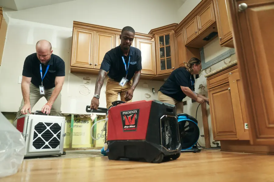 Restoration technician drying a water damaged Marietta, GA home with air movers
